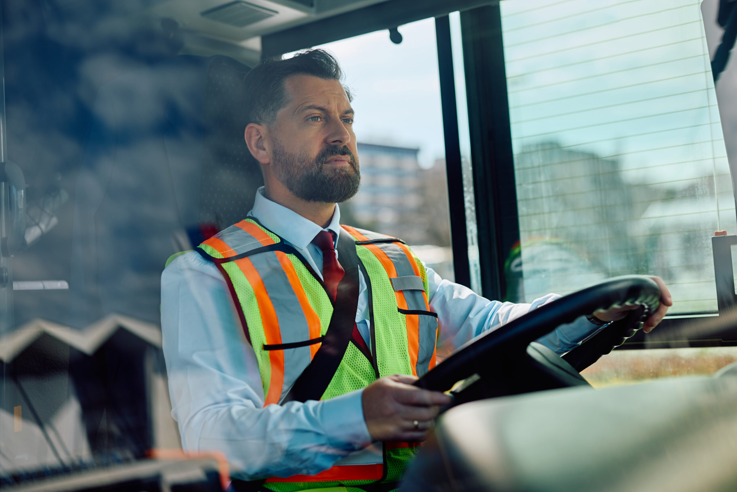 Mid adult man driving a school bus.